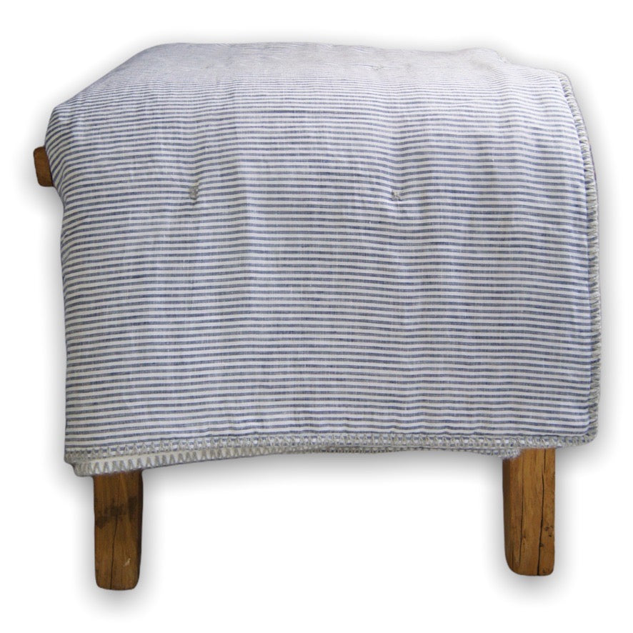 Handmade blue and white stripe linen and white sateen blanket with hand-embroidered edging