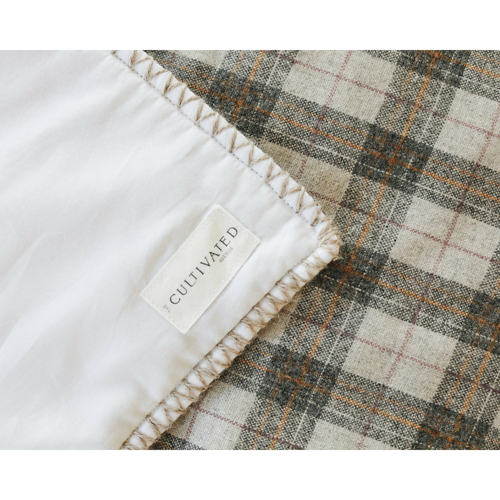 Handmade checked pattern wool & white sateen blanket with hand-embroidered edging